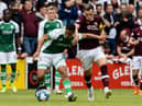 Allan Delferrière of Hibs shields the ball from Hearts forward Lawrence Shankland during the Edinburgh derby