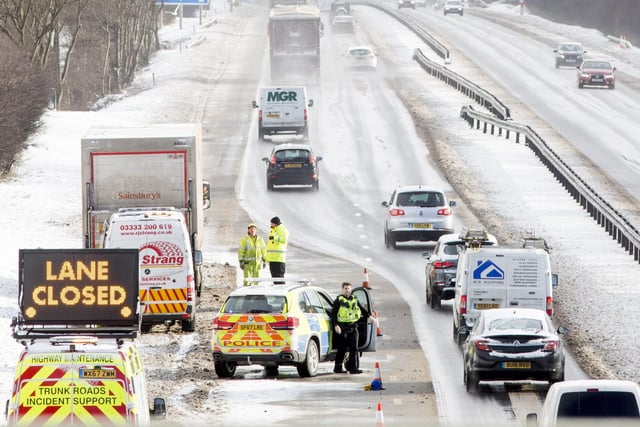 Police were forced to direct traffic on the M8 as commuters tried to make their way through after heavy snowfall on the M8 near Bathgate, West Lothian.