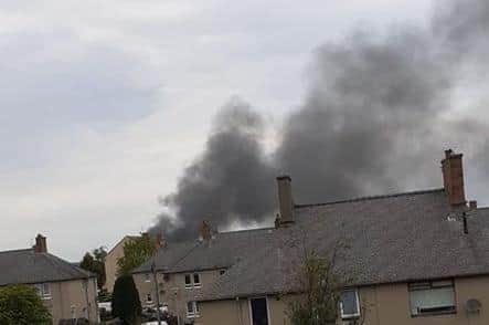 A plume of black smoke billows up above the Straiton area.