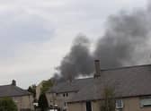 A plume of black smoke billows up above the Straiton area.