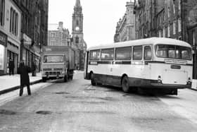 A Lothian Region Transport bus slips on the snow and gets stuck across the High Street Royal Mile Edinburgh, during the winter of 1979.