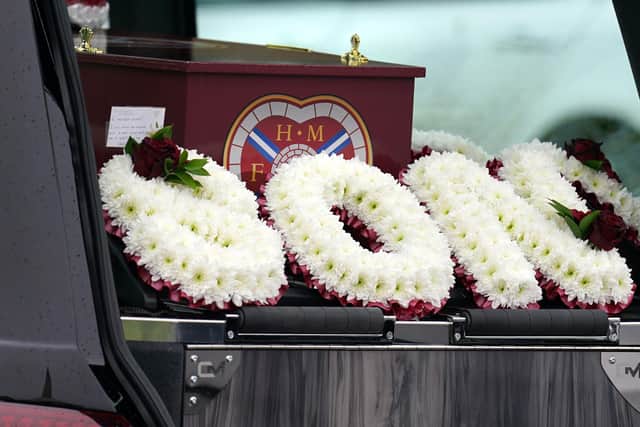 Floral tributes sit beside the coffin at the funeral of Andrew MacKinnon at St David's Church, Edinburgh. (Photo credit: Andrew Milligan/PA Wire)