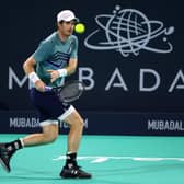 Britain's Andy Murray returns the ball to Britain's Dan Evans during their quarter-final match in the Mubadala World Tennis Championship in Abu Dhabi
