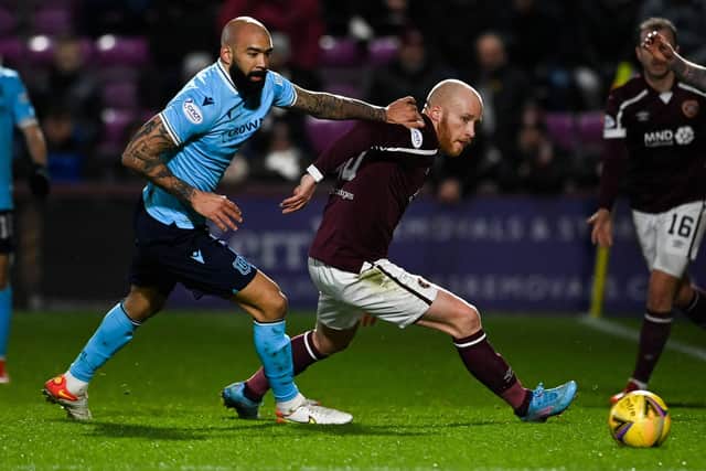 Liam Boyce, playing on the left side of the Hearts front three, fights off Dundee's Liam Fontaine