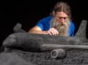 Artist Jamie Wardley working on one of his black sand sculptures commissioned by train operator LNER. Picture: Charlotte Graham
