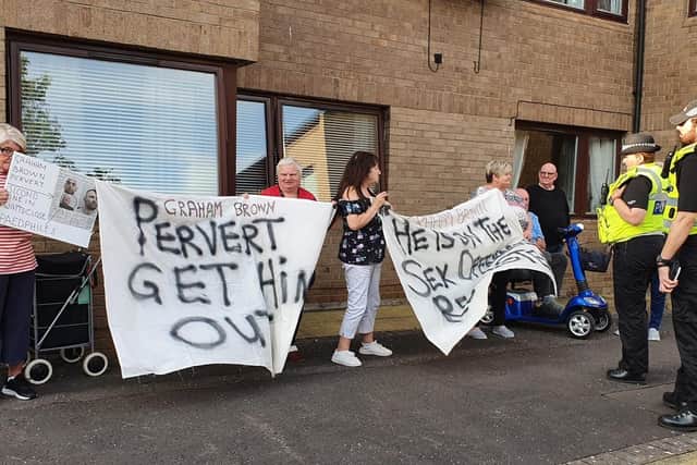Residents staged a peaceful demonstration outside a block of flats where convicted child sex offender Graham Brown has been placed by the local authority in Musselburgh.