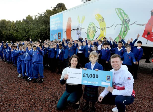 Team GB's cycle team sprinter Jack Carlin with teacher Rhona Robertson and competition winner Isabella pictured with her lorry design at Clifton Hall School, Newbridge.