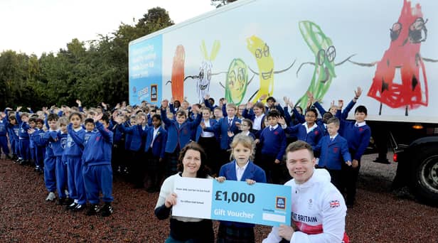 Team GB's cycle team sprinter Jack Carlin with teacher Rhona Robertson and competition winner Isabella pictured with her lorry design at Clifton Hall School, Newbridge.