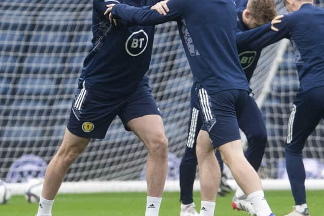 John Souttar and Andy Robertson stretch during Scotland training at Hampden Park yesterday. The Hearts centre-back was a late call-up to replace Grant Hanley