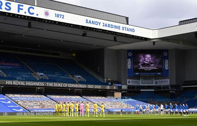 The players observe a minute's silence in memory of Prince Philip during a Scottish Premiership match between Rangers and Hibernian at Ibrox Stadium, on April 11, 2021, in Glasgow, Scotland. (Photo by Rob Casey / SNS Group)