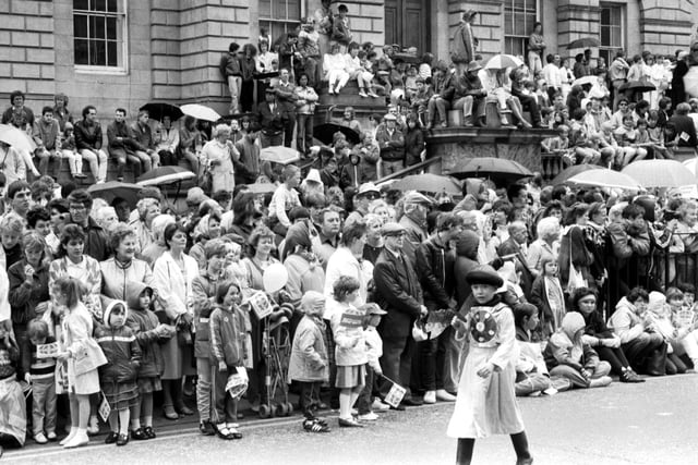 Crowds gathered in the rain outside resister House in Princes Street to watch the Evening news-sponsored Edinburgh Festival Cavalcade in August 1985.
