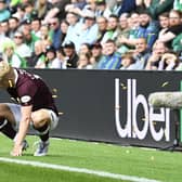 Alex Cochrane is targeted by objects thrown from the Hibs supporters