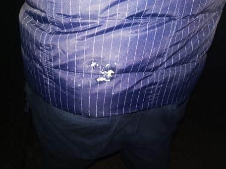 The woman took a photo of the stain on her husband's jacket.