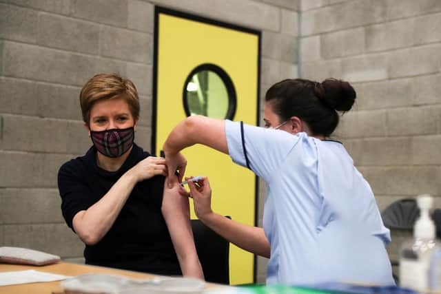 Scotland's First Minister Nicola Sturgeon (L) receives a COVID-19 booster vaccination in Glasgow on December 4, 2021. Photo by RUSSELL CHEYNE/POOL/AFP via Getty
