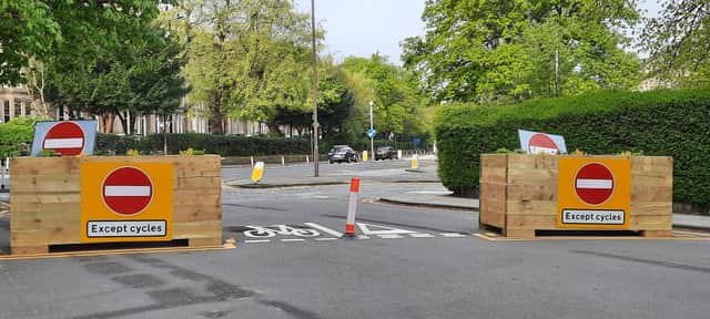 Planters and excessive signage at the end of a very quiet Edinburgh west end crescent