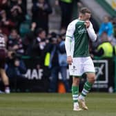 A dejected Aiden McGeady as Hearts players celebrate in front of their supporters during the 3-0 victory at Easter Road. Picture: SNS