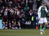 A dejected Aiden McGeady as Hearts players celebrate in front of their supporters during the 3-0 victory at Easter Road. Picture: SNS