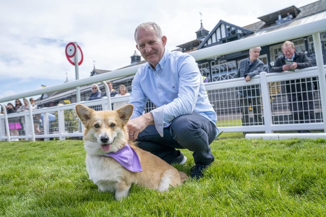 Winner Georgie with her owner Grant Rumbles at the finish line in the first ever Corgi Derby to mark 70 years of The Queen's reign, at Musselburgh Racecourse, on day four of the Platinum Jubilee celebrations.