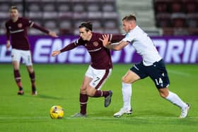 Jamie Walker battles for possession with Dundee defender Lee Ashcroft during Hearts' 6-2 win on opening weekend. Picture: SNS