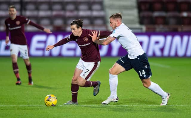 Jamie Walker battles for possession with Dundee defender Lee Ashcroft during Hearts' 6-2 win on opening weekend. Picture: SNS