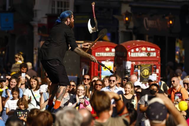 A Fringe street entertainer gathers a crowd on the Royal Mile (Picture: Jeff J Mitchell/Getty Images)