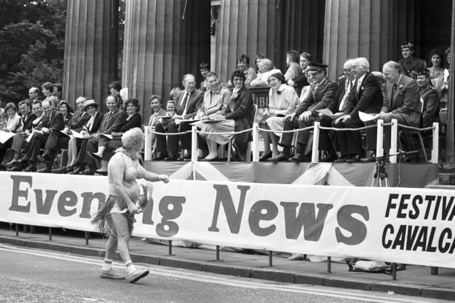 A man dressed as a 'South Sea Islander' causes great hilarity as he passes the VIP stand during the Edinburgh Festival Cavalcade in August 1985