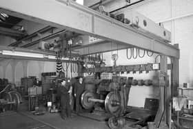 Workers with the wheel press in the wheelwrights workshop in the St Rollox Locomotive Works in Springburn, Glasgow
Pic: HES