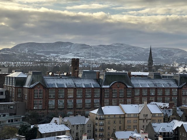 The snow-clad hills can be spotted in the distance, beyond the rooftops.
