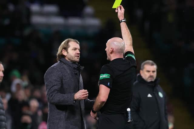 Hearts boss Robbie Neilson is booked by referee Bobby Madden for taking his protestations too far in the mind of the official. Picture: SNS