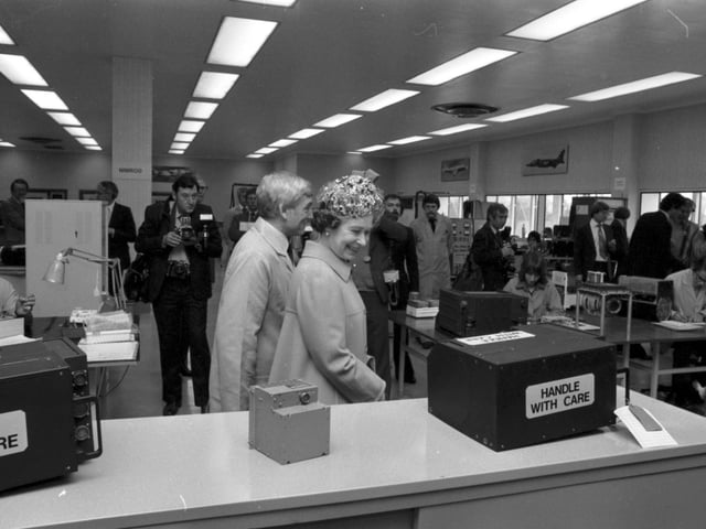 Queen Elizabeth II visits the Ferranti electronics factory at Silverknowes Edinburgh in July 1980. The Queen smiles at the Handle With Care sign on the box.