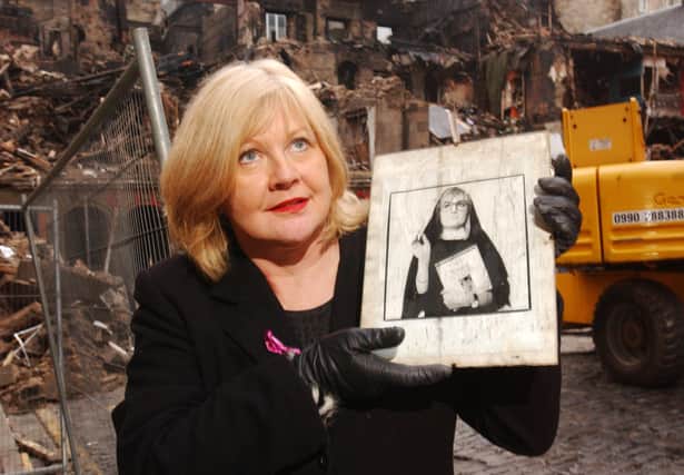 Photo: Andrew Stuart/NW
Artistic Director Karen Koren of Fringe venue the Gilded Balloon seen here with an archive photograph of former venue performer comediene Caroline Aherne which was salvaged from the debris of destroyed club premises (behind) on the Cowgate, Edinburgh; December 22, 2002. The Gilded Balloon, the world renown comedy venue which Koren founded 17 years ago, was destroyed by the fire of the 7th December which gutted the Old Town block bordering the Cowgate and South Bridge.