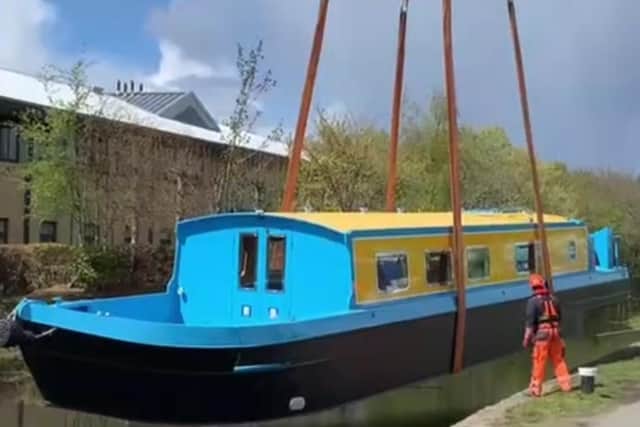 The “All Aboard” was lifted off the back of a lorry by crane and lowered into the Union Canal at Wester Hailes this week. Pic: Church of Scotland