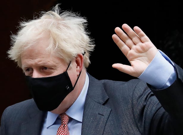 Britain's Prime Minister Boris Johnson wears a face mask due to the Covid-19 pandemic, as he leaves 10 Downing Street in central London in September 2020