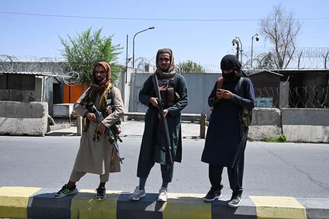Taliban fighters stand guard on a street in Kabul after a stunningly swift end to Afghanistan's 20-year war (Picture: Wakil Kohsar/AFP via Getty Images)