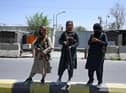 Taliban fighters stand guard on a street in Kabul after a stunningly swift end to Afghanistan's 20-year war (Picture: Wakil Kohsar/AFP via Getty Images)