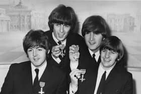 The Beatles each received an MBE at Buckingham Palace, 26th October 1965. From left to right, Paul McCartney, George Harrison, John Lennon, Ringo Starr. (Photo by Central Press/Hulton Archive/Getty Images)