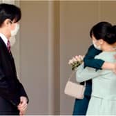 Princess Mako, at right, hugs her sister, Princess Kako, watched by their parents, Crown Prince Fumihito and Crown Princess Kiko, in Tokyo on Tuesday. Koki Sengoku / AP