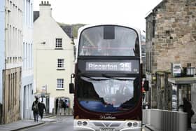 The number 35 Lothian Bus drives up the Royal Mile
