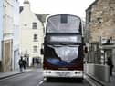 The number 35 Lothian Bus drives up the Royal Mile