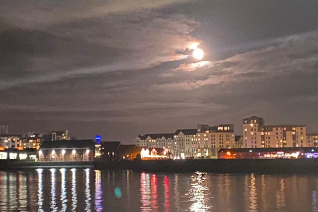 The Wolf Moon rises above Newhaven Harbour, casting a silver reflection into the sea