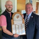DP World Tour caddie Scott Carmichael reveives the Baberton Club Championship Trophy from captain Jim Downie.