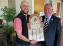 DP World Tour caddie Scott Carmichael reveives the Baberton Club Championship Trophy from captain Jim Downie.