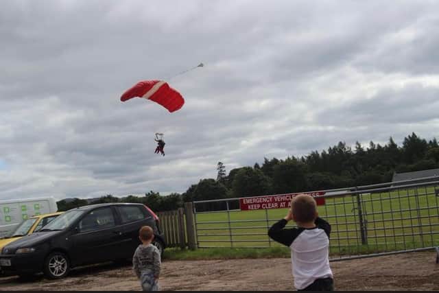 Ms Campbell's two son's Riley, four and Logan, two watching their mum land.