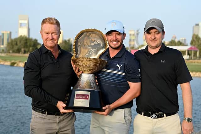 Ewen Ferguson flanked by coach Jamie Gough, left, and caddie Stephen Neilson, right, after his weekend win in Qatar. Picture: Stuart Franklin/Getty Images.