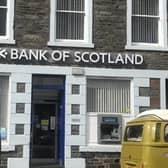 Bank of Scotland owner Lloyds Banking Group saw its pre-tax profits almost wiped out after taking a major hit from worsening economic conditions in the first three months of the year.