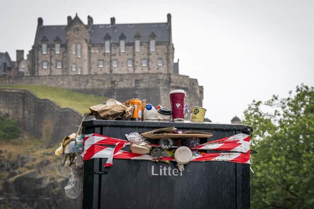 A bin overflowing with litter on Castle Street in Edinburgh city centre. Picture: Jane Barlow/PA Wire