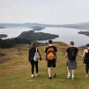 Hillwalkers take in the view from Conic Hill overlooking Loch Lomond