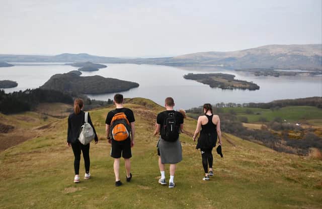 Hillwalkers take in the view from Conic Hill overlooking Loch Lomond