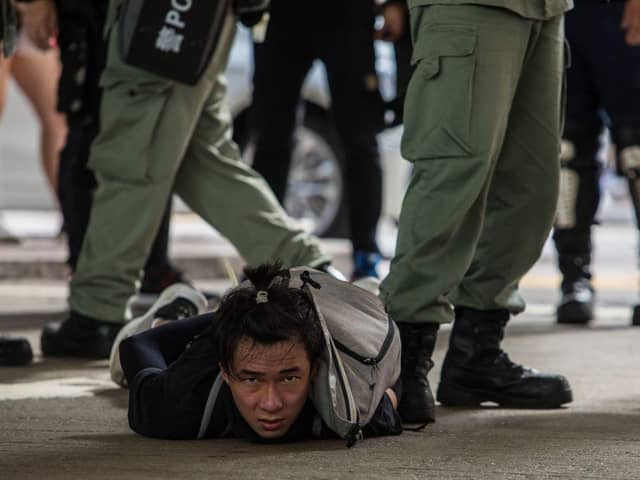 Riot police detain a man as they clear protesters taking part in a rally against a new national security law in Hong Kong on 1 July 2020, on the 23rd anniversary of the city's handover from Britain to China (Photo: DALE DE LA REY/AFP via Getty Images)