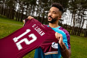 Shay Logan is uneveiled as a Hearts player after signing on loan from Aberdeen.